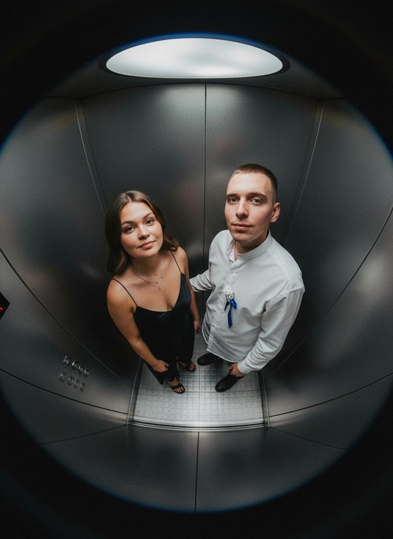 Используй предоставленные изображения и создай фото с двумя людьми в лифте с металлическими стенами. Цветовая гамма с преообладанием серых металлических оттенков. Кадр снят с максимально верхнего ракурса, люди будто заглядывают в камеру, их головы подняты наверх, взгляд в камеру. Легкий эффект fish eye. Реалистичное фото. Зернистость пленочного фото, насыщенные цвета, стиль фото y2k. Сохрани черты лица людей. Они стоят лицом в камеру 