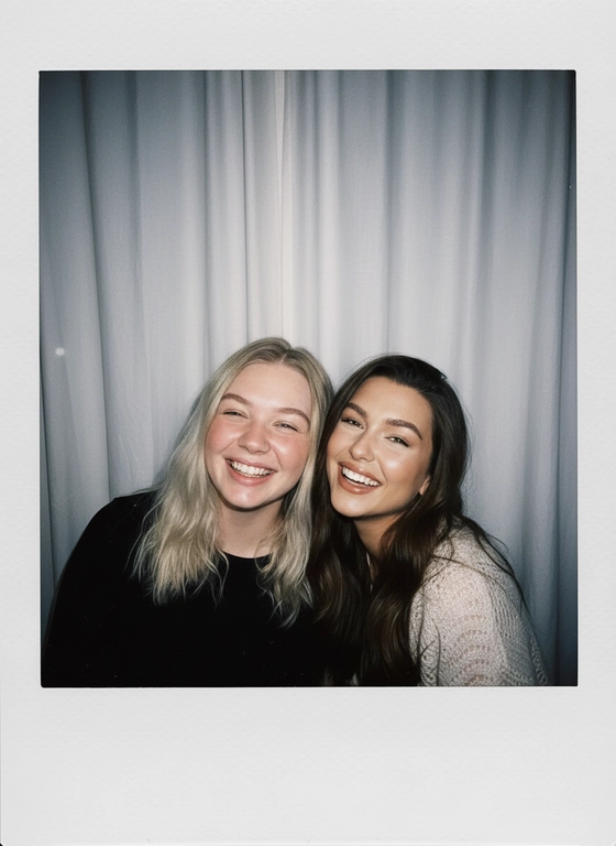 Take a picture with a Polaroid camera. the photo should look like a normal photo, without any clear subject or props. The photo should have a consistent light source such as a flash from a dark room, spread throughout the photo. Do not change the faces. Replace the background behind the two people with a white curtain. Люди на фото позируют вместе, улыбаясь в камеру.