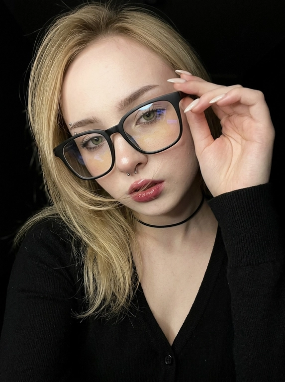 Максимально реалистичная фотография, темная винтажная эстетика в стиле dark glam glasses selfie, атмосферный ночной портрет.
Крупный портрет (Close-Up Portrait), кадр по грудь. Модель делает селфи, телефон не видно. Лицо занимает большую часть кадра, слегка повернуто вполоборота к камере. Голова немного наклонена. Взгляд направлен прямо в объектив, выражение спокойное, уверенное и притягательное. Губы слегка приоткрыты. Одна рука поднята к лицу и аккуратно касается оправы очков, словно поправляя их.
Макияж: Безупречный dark glam makeup. Ровный сияющий тон кожи, четко оформленные темные брови, длинные густые ресницы, тонкая стрелка, мягкий контуринг. Губы розово-винного оттенка с влажным глянцевым финишем.


Аксессуары: Крупные черные очки с прозрачными линзами и массивной квадратной оправой. На линзах заметны мягкие отражения света. Маленькие серьги-гвоздики. Длинный миндалевидный маникюр молочно-бежевого оттенка.

Одежда: Черный лонгслив с глубоким вырезом и небольшими пуговицами спереди. Темная ткань почти сливается с фоном, сохраняя видимую текстуру и силуэт.

Локация: Фон полностью черный.

Освещение: Мягкий приглушенный свет спереди и немного сбоку, словно от экрана телефона. Свет деликатно подсвечивает лицо, очки, губы, пальцы и ногти, оставляя волосы и одежду в глубоких тенях.

Камера: Реалистичное селфи высокого качества, RAW photo, натуральная перспектива смартфона, высокая детализация лица и аксессуаров.

Глубина резкости: Небольшая. Лицо, очки, губы и рука находятся в фокусе, фон растворяется в мягкой темноте.

Кожа: Реалистичная текстура кожи с видимыми порами, естественными переходами света и тени, без эффекта пластика и чрезмерной ретуши.

Детали: Блики на линзах очков, влажный блеск губ, отдельные волоски и пряди на лице, текстура ткани, отражения света на ногтях, легкое пленочное зерно.

Атмосфера: Загадочный ночной вайб, уверенность, женственность, винтажная эстетика, ощущение случайного красивого селфи в темноте.

Какая будет прическа?: Волосы перекинуты на одну сторону. Несколько тонких прядей проходят через щеку и губы, создавая живой эффект движения. Видна естественная текстура и мягкий блеск.