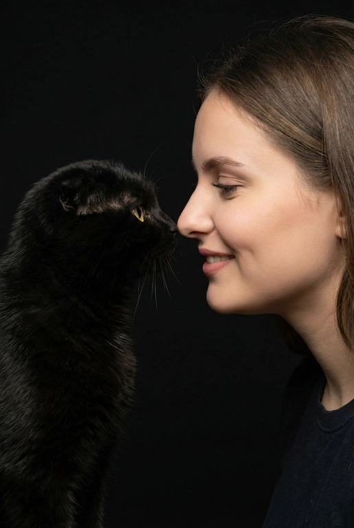 Сделай фото со мной и моим питомцем. Реалистичное фото, с высокой детализацией. Снимок меня и моего питомца в профиль. Фото сделано первым средним планом (Medium CloseUP), в кадре видно часть туловища (с головы до середины груди).
Я стою лицом к своему питомцу в строгий профиль, смотрю прямо на него.
Мой питомец расположен прямо напротив моего лица, также в профиль, смотрит прямо на меня. Наши носы почти соприкасаются. Наши головы могут быть наклонены: например, моя голова наклонена немного вниз, а голова питомца наоборот повыше. Четкая визуальная симметрия между моем лицом и головой моего питомца.
Студийное освещение, мягкий свет, создающий контрастность и скульптурные тени, на самом лице минимум тени. 
 У меня легкая улыбка, питомец смотрит с дружелюбным настроем. Фон черный. 