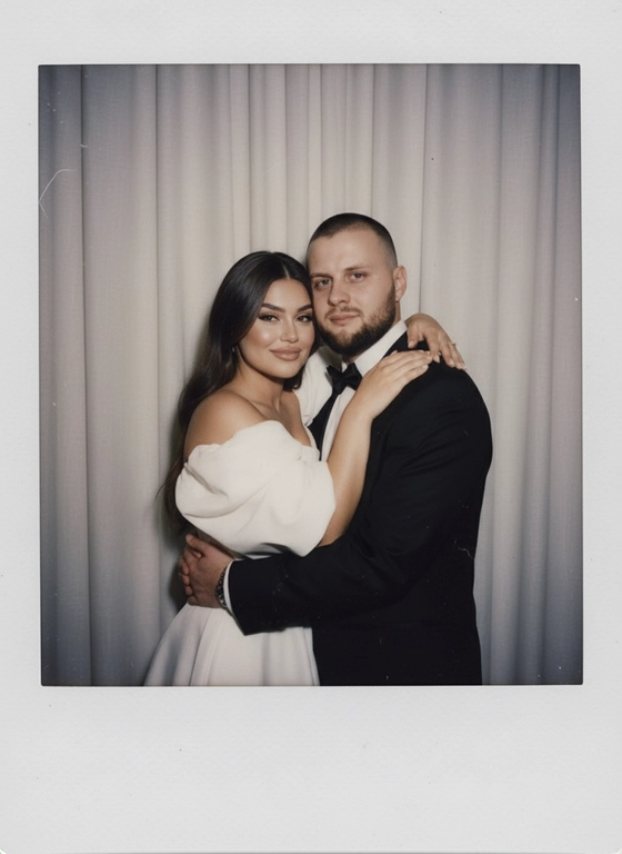 Take a picture with a Polaroid camera. the photo should look like a normal photo, without any clear subject or props. The photo should have a consistent light source such as a flash from a dark room, spread throughout the photo. Do not change the faces. Replace the background behind the two people with a white curtain. Люди на фото обнимаются.