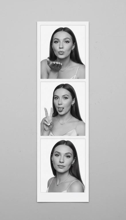  Используя мою фотографию в качестве референса для лица и волос, не изменяя исходные черты лица и сохраняя верность моим физическим характеристикам, создайте ленту из фотографий в ч/б с тремя вертикальными белыми рамками. Лента выглядит так, будто лежит на столе или фоне. Фотографии выглядят профессионально , как будто из настоящей фотобудки. 

В каждой рамке по центру расположены портрет и фотография погрудной проекции одного и того же человека. Взгляд прямо в камеру.

Общая эстетика винтажная, с лёгкой зернистостью и выцветшим качеством, напоминающая классическую аналоговую фотографию. Но при этом изображение выполнено в высоком разрешении. На светло-сером фоне видны едва заметные следы пыли и царапин. Лица человека на белом фоне. 
НЕ ИЗМЕНЯЙТЕ МОЁ ЛИЦО. На верхнем фото девушка посылает зрителю воздушный поцелуй, поднеся правую руку ко рту и слегка поджав губы. Выражение её лица игривое и дружелюбное.  На среднем фото девушка мило и игриво показывает знак мира, высунув язык. Брови слегка приподняты. На нижнем фото девушка позирует, отвернувшись к плечу, смотрит прямо в камеру с более спокойным и уверенным выражением лица. Губы мягко сжаты, взгляд прямой и чувственный. ОДЕЖДА: На ней маленькие серьги-кольца и изящное ожерелье с символом бесконечности поверх светлого атласного или шёлкового топа. На ней естественный макияж, включая глянцевый блеск для губ, лёгкую подводку для глаз и кукольные нарощенные ресницы, без излишеств. У неё квадратный французский маникюр. 