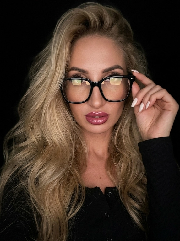 Максимально реалистичная фотография, темная винтажная эстетика в стиле dark glam glasses selfie, атмосферный ночной портрет.
Крупный портрет (Close-Up Portrait), кадр по грудь. Модель делает селфи, телефон не видно. Лицо занимает большую часть кадра, слегка повернуто вполоборота к камере. Голова немного наклонена. Взгляд направлен прямо в объектив, выражение спокойное, уверенное и притягательное. Губы слегка приоткрыты. Одна рука поднята к лицу и аккуратно касается оправы очков, словно поправляя их.
Макияж: Безупречный dark glam makeup. Ровный сияющий тон кожи, четко оформленные темные брови, длинные густые ресницы, тонкая стрелка, мягкий контуринг. Губы розово-винного оттенка с влажным глянцевым финишем.


Аксессуары: Крупные черные очки с прозрачными линзами и массивной квадратной оправой. На линзах заметны мягкие отражения света. Маленькие серьги-гвоздики. Длинный миндалевидный маникюр молочно-бежевого оттенка.

Одежда: Черный лонгслив с глубоким вырезом и небольшими пуговицами спереди. Темная ткань почти сливается с фоном, сохраняя видимую текстуру и силуэт.

Локация: Фон полностью черный.

Освещение: Мягкий приглушенный свет спереди и немного сбоку, словно от экрана телефона. Свет деликатно подсвечивает лицо, очки, губы, пальцы и ногти, оставляя волосы и одежду в глубоких тенях.

Камера: Реалистичное селфи высокого качества, RAW photo, натуральная перспектива смартфона, высокая детализация лица и аксессуаров.

Глубина резкости: Небольшая. Лицо, очки, губы и рука находятся в фокусе, фон растворяется в мягкой темноте.

Кожа: Реалистичная текстура кожи с видимыми порами, естественными переходами света и тени, без эффекта пластика и чрезмерной ретуши.

Детали: Блики на линзах очков, влажный блеск губ, отдельные волоски и пряди на лице, текстура ткани, отражения света на ногтях, легкое пленочное зерно.

Атмосфера: Загадочный ночной вайб, уверенность, женственность, винтажная эстетика, ощущение случайного красивого селфи в темноте.

Какая будет прическа?: Не менять мою прическу