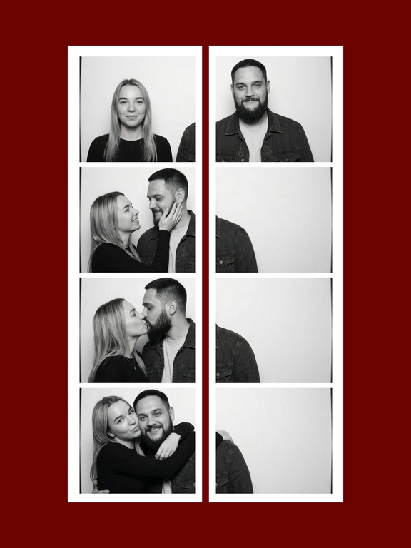 A black-and-white vertical vintage photobooth strip 1X4 of a man and a woman. The man wears a dark denim jacket over a light T-shirt. The woman wears a fitted semi-sheer black long-sleeve top with delicate small patterned details. Realistic candid couple energy, authentic photobooth snapshot feel, not too polished, not perfectly symmetrical, natural imperfect posing. All frames are stacked in a one column, one frame under another. Plain light studio background, strictly white photobooth borders with same width and square corners, realistic analog photobooth aesthetic, gentle film grain, soft contrast, natural skin texture, even frontal photobooth lighting. Frame 1: both stand side by side facing the camera, the woman on the left and the man on the right, slight height imbalance preserved, empty space between them, symmetrical centered composition. The woman's head slightly turned to the right, a flirtatious smile, a glance to the side. Frame 2: the woman turns toward the man and gently holds his cheek with one hand, smiling brightly; the man turns toward her with a soft smile. Their faces are close, but the composition remains off-center and slightly left-weighted, with more negative space on the right. Frame 3: the couple kiss in profile, the woman on the left and the man on the right, the couple is positioned close to the left side of the frame, extra empty space on the right side. The woman on his left, her hand on the men's cheek. Frame 4: the woman hugs the man from behind over his shoulders, her head leaning from the upper left side toward him, while the man faces the camera smiling. the couple is positioned very close to the left side of the frame, the right half of the frame is empty.