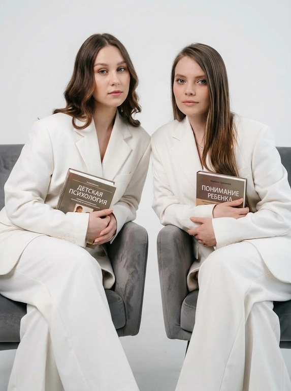 Студийный портрет женщин в белых костюмах с книгами