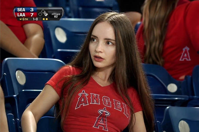 Person sitting in the crowd at a professional baseball game (or it could be any other match that I will write below), filmed from far away by a live broadcast camera. 
Seated in blue stadium chairs, slightly leaned back, looking off to the side with a surprised caught-on-camera expression, lips slightly parted.

Какая будет одежда? : красная футболка болельщицы

Доп. характеристики: стройное телосложение, худые руки, маленькая грудь